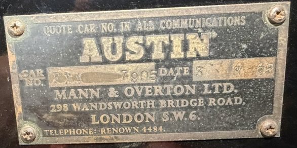 A weathered metal plate reading Quote car no. in all communications, Austin, Mann and Overton Ltd, 298 Wandsworth Bridge Road, London S.W.6, Telephone Renown 4484.